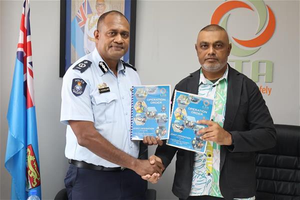 Acting Assistant Commissioner of Police Operations Kasiano Vusonilawe, left, and LTA Chief Operating Officer Imran Ali formalise the joint road safety operations order.